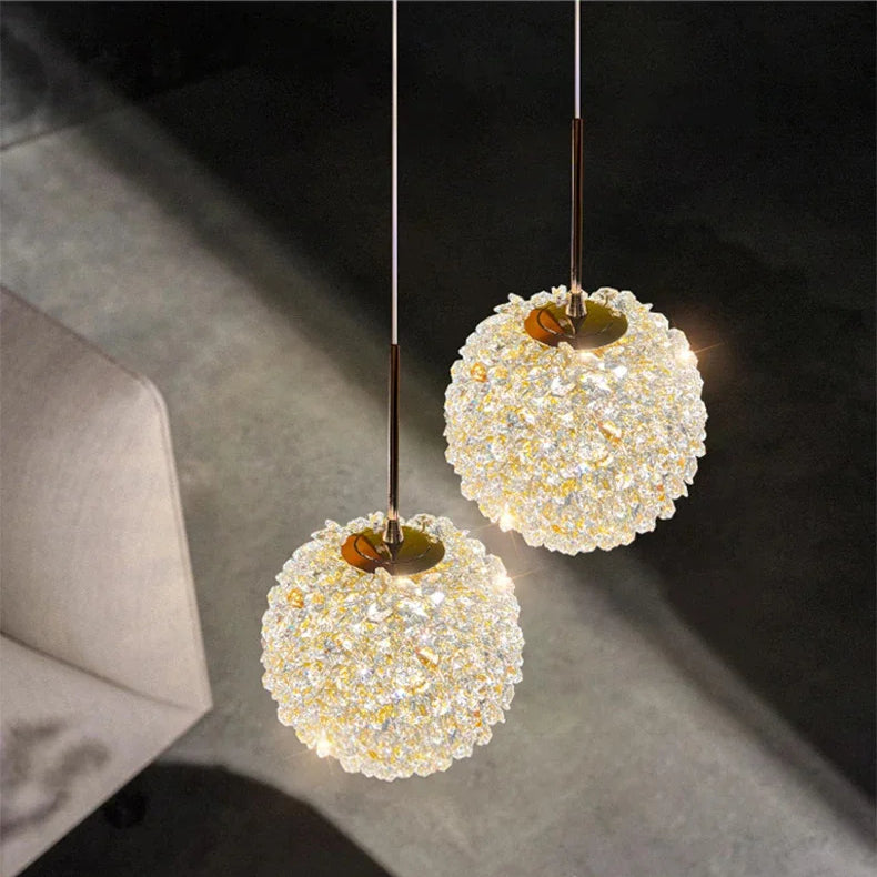 Two spherical pendant lights hanging in a room with a neutral background